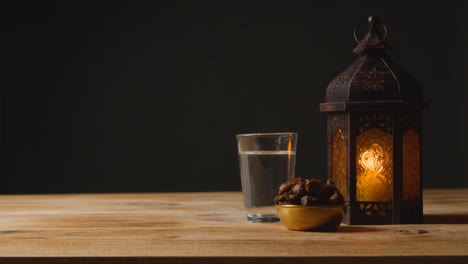 Stationary-Shot-of-Lantern-Water-and-Dates-On-a-Table-for-Ramadan